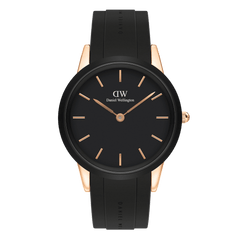 Rose gold women’s sport watch with black dial, minimalist markers, and black rubber strap by Daniel Wellington.