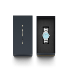 Daniel Wellington Iconic Link Capri Silver women’s watch with pastel blue dial, presented in a branded gift box.