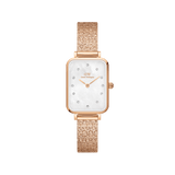 Rectangular rose gold women’s watch with a pressed piano link strap, featuring a white mother of pearl dial and crystal hour markers.