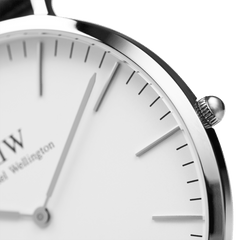 Close-up of Classic Sheffield Silver watch showing polished stainless steel case, minimalist white dial and silver hands.