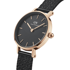 Daniel Wellington Petite Pressed Ashfield watch with a slim rose gold case, minimalist black dial, and an elegant black pressed mesh strap.