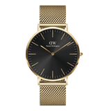 Gold mesh wristwatch with a black sunray dial, minimalist gold markers, and a slim round case, showcasing elegant and contemporary design.