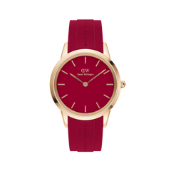 Rose gold Daniel Wellington watch with a bold red dial and matching ruby red rubber strap, featuring minimalist hour markers and a sleek, contemporary design.