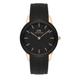 Women’s sport watch with black dial, rose gold case, minimalist markers, and black rubber strap by Daniel Wellington.