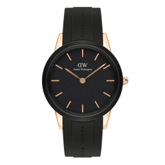 Women’s sport watch with black dial, rose gold case, minimalist markers, and black rubber strap by Daniel Wellington.