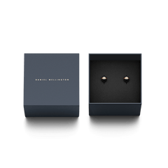 Aspiration Earrings Rose Gold Black presented in a sleek navy Daniel Wellington gift box, showcasing the elegant black ceramic and rose gold stud design.