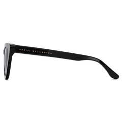 Side view of the Lynx Bio-Acetate Black sunglasses showing the glossy black temple with gold Daniel Wellington branding.