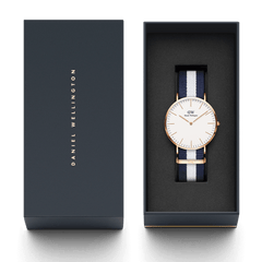 Classic Glasgow Rose Gold watch with a navy and white striped NATO strap, presented in an elegant Daniel Wellington gift box.
