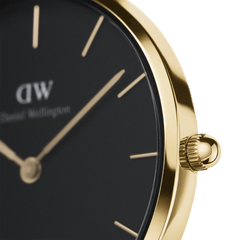 Close-up of Petite Sheffield Gold women’s watch showing black dial, gold case, minimalist markers, and polished crown.