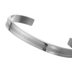 Close-up of the Daniel Wellington Elan Bracelet Silver, showcasing its polished stainless steel finish, minimalist cuff shape, and engraved logo detail.
