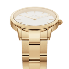 Daniel Wellington Iconic Link ladies gold watch with white dial, minimalist gold markers and brushed gold stainless steel bracelet.