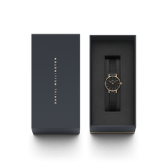 Petite Pressed Ashfield watch with a black mesh strap and rose gold case, elegantly presented in a Daniel Wellington gift box.