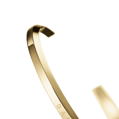 Detail view of the Classic Bracelet Gold by Daniel Wellington, showing the polished gold PVD coating and slim open cuff design.