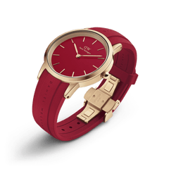 Daniel Wellington Iconic Motion Ruby watch featuring a rose gold stainless steel case, vibrant red dial, ruby red FKM rubber strap, and a matching rose gold deployment clasp.