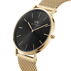Classic Mesh Onyx Gold wristwatch featuring a slim gold stainless steel case, black sunray dial, and a woven gold mesh strap with minimalist detailing.