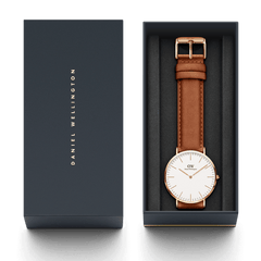 Classic Durham Rose Gold watch with a light brown leather strap, presented in an elegant dark Daniel Wellington gift box.