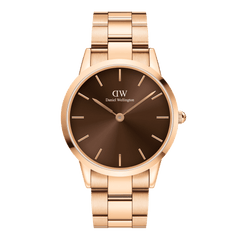 Rose gold Daniel Wellington watch with a sunray-finished amber brown dial and a polished link bracelet, featuring minimalist hour markers and a sleek, modern design.