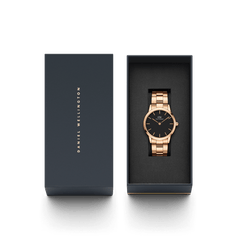 Daniel Wellington Iconic Link Rose Gold watch with black dial, presented in a navy gift box, perfect for gifting.