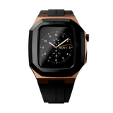 Switch Rose Gold Apple Watch case in brushed rose gold stainless steel with a bold black bezel and black synthetic rubber strap, featuring a geometric design and deployment clasp.