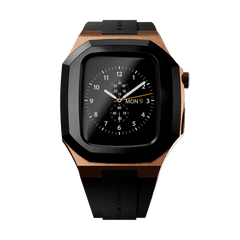 Switch Rose Gold Apple Watch case in brushed rose gold stainless steel with a bold black bezel and black synthetic rubber strap, featuring a geometric design and deployment clasp.
