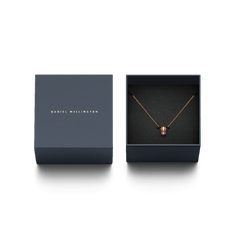 Emalie Necklace Cherry Blush Rose Gold displayed in an elegant navy gift box, featuring a rose gold chain and cherry blush enamel barrel pendant.