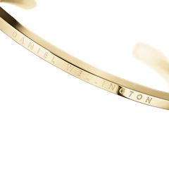 Close-up of the Classic Bracelet Gold by Daniel Wellington, highlighting the polished gold finish and engraved logo detail.
