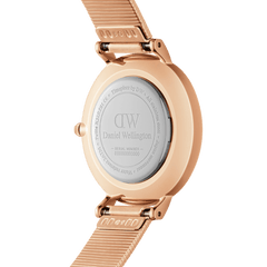 Close-up of the Petite Lumine Pressed Piano Black MoP Rose Gold watch case back, showing the engraved Daniel Wellington logo and rose gold pressed mesh strap.