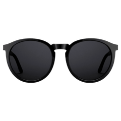 Round black sunglasses with a polished bio-acetate frame and dark lenses, featuring a minimalist bridge and gently curved arms.