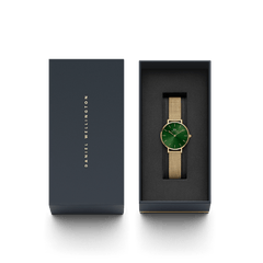 Petite Emerald Gold women’s watch with emerald green dial and gold mesh strap, presented in a Daniel Wellington gift box.