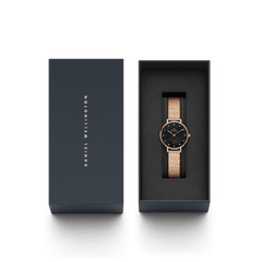 Petite Lumine Pressed Piano Black MoP Rose Gold watch with a black mother-of-pearl dial and rose gold mesh strap, elegantly presented in a Daniel Wellington gift box.