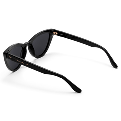 Lynx Bio-Acetate Black sunglasses with a cat eye design, dark lenses, and gold Daniel Wellington branding on the sleek black arms.