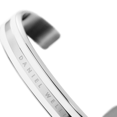 Close-up of the Daniel Wellington Emalie Bracelet highlighting the polished silver-tone stainless steel, satin white enamel, and engraved logo detail.