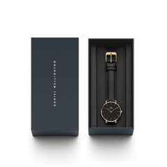 Petite Sheffield Gold women’s watch with black leather strap and gold case, elegantly presented in a Daniel Wellington gift box.