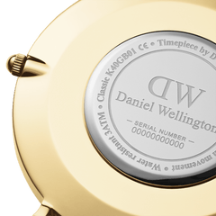 Close-up of Daniel Wellington Classic St Mawes Gold watch case back, showing engraved logo, model details and gold finish.