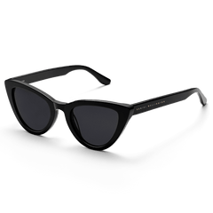 Lynx Bio-Acetate Black sunglasses with a sleek cat eye shape, glossy black bio-acetate frame, dark lenses, and subtle Daniel Wellington branding on the temple.