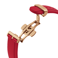 Detail of the Daniel Wellington Iconic Motion Ruby watch showing the ruby red FKM rubber strap with a secure rose gold deployment clasp.