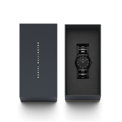Daniel Wellington Iconic Link Ceramic watch with a black ceramic bracelet, presented in an elegant branded gift box.