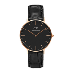 Minimalist black dial watch with a rose gold case and black croc-embossed leather strap, featuring slim rose gold hour markers and hands.