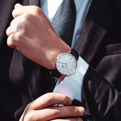 Classic Sheffield Rose Gold watch with black leather strap, worn with a suit for a sophisticated, formal look.