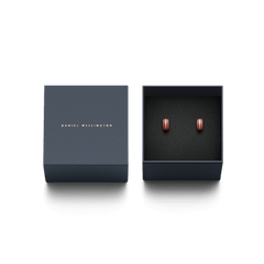 Pair of Emalie rose gold and cherry blush enamel hoop earrings presented in an elegant navy Daniel Wellington gift box.