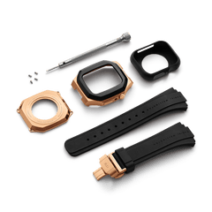 Switch Rose Gold Apple Watch case kit shown disassembled, including the rose gold and black case, black synthetic rubber strap with deployment clasp, back plate, screws, screwdriver, and protective cover.