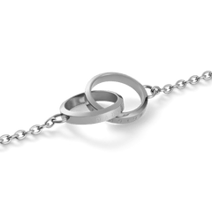 Close-up of the Elan Unity Necklace Silver, featuring two polished interlocking rings with subtle Daniel Wellington engraving on a fine silver chain.