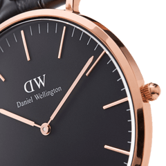 Detail view of the Classic St Mawes watch showing the black dial, rose gold hour markers and hands, and polished rose gold case.