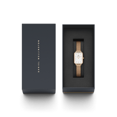 Quadro Pressed Melrose watch with a rectangular eggshell white dial and rose gold mesh strap, presented in an elegant Daniel Wellington gift box.