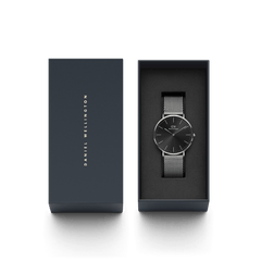 Classic Mesh Onyx watch with a black sunray dial and silver mesh strap, elegantly presented in Daniel Wellington’s signature gift box.
