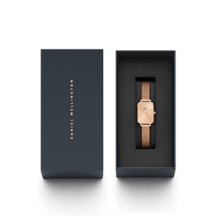 Quadro Pressed Unitone rose gold women’s watch with a rectangular dial and mesh strap, elegantly presented in a sleek Daniel Wellington gift box.