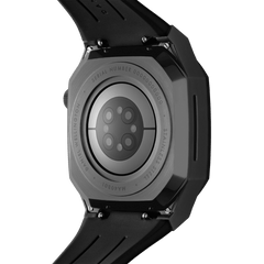 Close-up of the back of the Switch Black Black Daniel Wellington Apple Watch case, showing the brushed stainless steel finish, engraved detailing, and integrated black rubber strap.