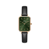 Rectangular women’s watch with an emerald green dial, rose gold-plated case, minimalist markers, and a black leather strap.