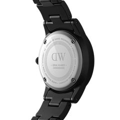 Back view of the Iconic Link Ceramic watch showing the stainless steel case back engraved with Daniel Wellington branding and the black ceramic bracelet.