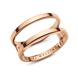 Polished rose gold dual band ring with a modern open structure and subtle Daniel Wellington engraving on the inside.